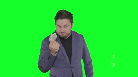 bearded-caucasian-actor-playing-with-paper-money-in-front-of-camera-alpha-channel-green-screen