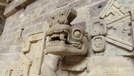 Carved-stone-relief-animal-head-in-wall-at-ancient-Mayan-Copan-ruins