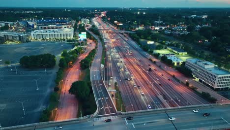 Aerial-birds-eye-shot-of-busy-traffic-on-highway-of-Atlanta-City-after-golden-sunset-in-the-evening---Georgia-State-Stadium-in-background
