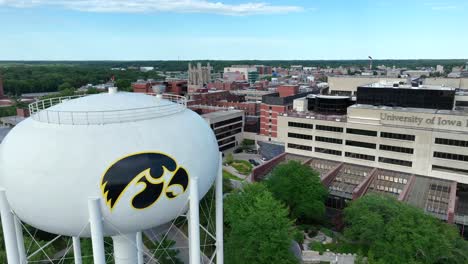 University-of-Iowa-logo-on-branded-water-tower-and-building-on-college-campus