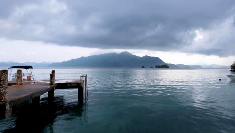 Peacefulness-of-Coron-Bay-in-Palawan,-Philippines-during-off-season-on-a-wet,-grey,-cloudy-and-rainy-day-overlooking-ocean-and-remote-tropical-island