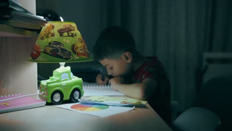child-doing-homework-at-night-on-his-desk