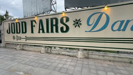 Panning-shot-view-of-the-new-Jodd-Fairs-Danneramit-night-market-signage-board-in-Bangkok,-Thailand