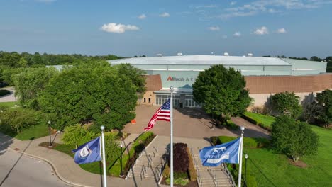 American,-Kentucky,-and-Horse-Park-flags-waving-in-front-of-the-Alltech-Arena-at-Kentucky-Horse-Park