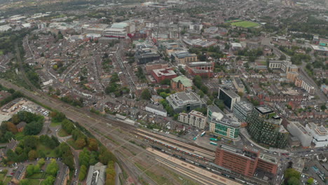 Aerial-shot-over-high-speed-train-passing-through-Watford-Junction-station-looking-towards-Watford-town