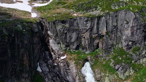 Reveal-of-waterfall-and-water-reservoir-at-the-resort-of-Weissee-Gletscherwelt,-Austria