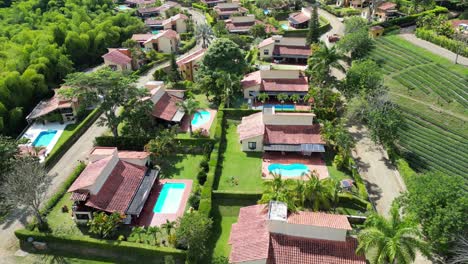 Aerial-view-of-fincas-with-trees-and-pools-close-to-Panaca-in-Quindio-Colombia
