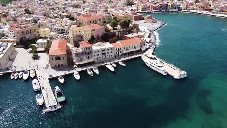 Iconic-Greek-building-and-pier-of-Chania-city,-aerial-view