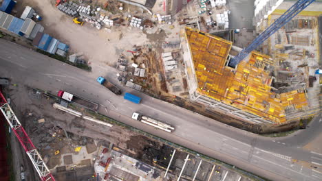 Bird's-eye-view-of-a-construction-site-beside-a-busy-road-with-traffic