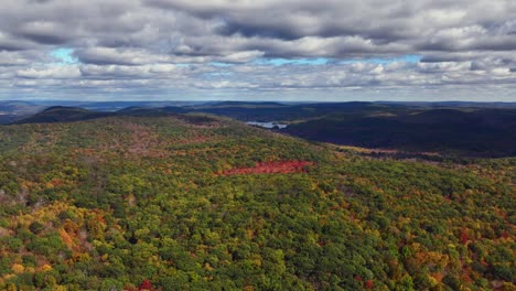 An-aerial-view-of-the-colorful-treetops-in-Putnam-County,-NY-as-they-begin-to-change-for-autumn