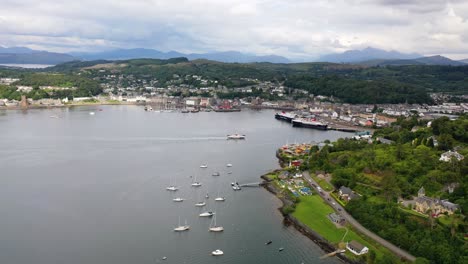 Aerial-Footage-of-A-Scottish-Ferry-Arriving-in-a-Port,-Oban,-Scotland,-United-Kingdom