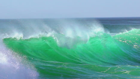 Cinematic-slow-motion-stunning-aqua-blue-huge-wave-surf-swell-wind-froth-Hossegor-Seignosse-Biarittz-Basque-Country-European-holiday-destination-WSL-ocean-tide-stunning-summer-day-pan-follow-right