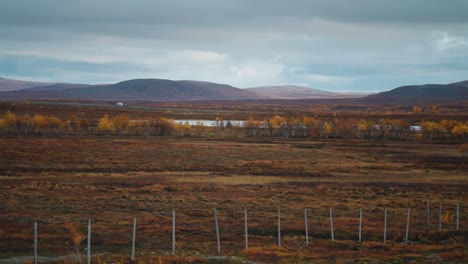 A-car-with-a-caravan-on-the-road-in-autumn-tundra