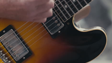 Guitarist-Hand-Strumming-Electric-Guitar.---close-up