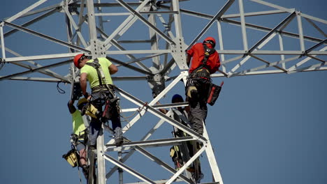 Close-up-of-workers-at-height-in-a-high-voltage-pole