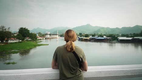 Female-Tourist-Traveler-Looking-Over-The-Khwae-Yai-River-In-Kanchanaburi,-Thailand