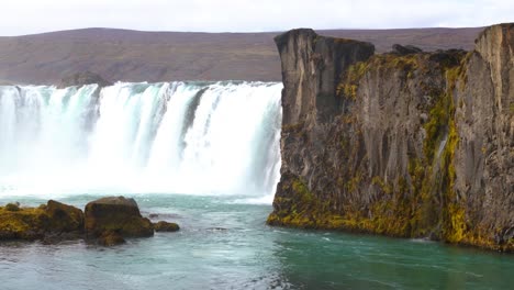 Low-orbiting-shot-of-famous-tourist-location-Goðafoss-Waterfall,-Iceland