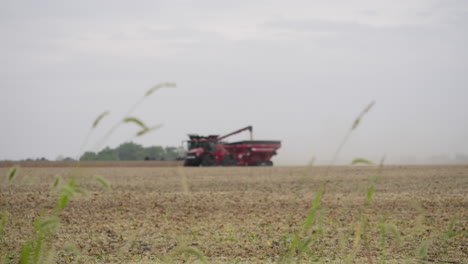 Combine-Harvester-Working-in-a-Grain-Field-with-Pull-Focus-from-Foreground-Plants