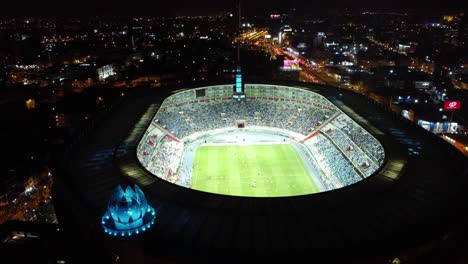 Estadio-Deportivo-Por-La-Noche-Con-Un-Partido-De-Fútbol-Que-Se-Juega-Con-Apuestas-Deportivas-En-Línea-Del-Partido-En-El-Estadio-Nacional-De-Lima,-Perú.