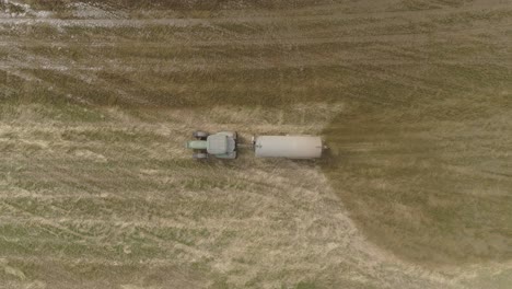 Tractor-with-a-trailer-spreading-fertilizer-Aerial-View