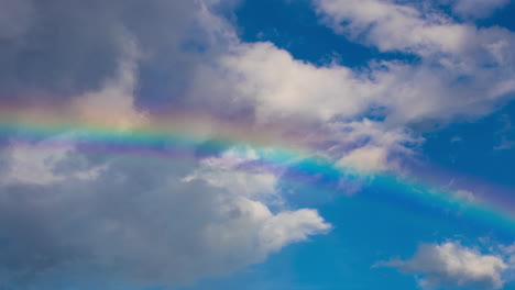 Rainbow-In-sky-with-time-lapse-clouds-in-motion