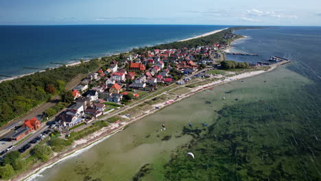 Drone-shot-of-Kuznica-City-on-Hel-Island-with-turquoise-baltic-sea-and-corals-underwater---wide-shot