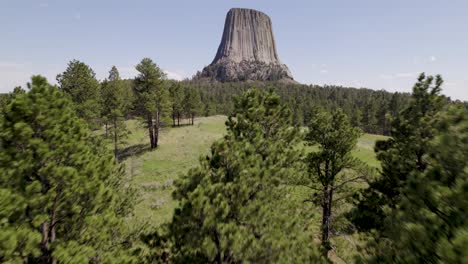 A-drone-shot-of-Devils-Tower,-a-massive,-monolithic,-volcanic-stout-tower,-or-butte,-located-in-the-Black-Hills-region-of-Wyoming