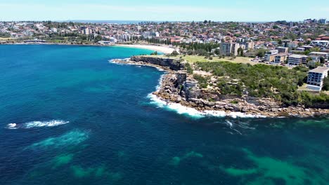 Drone-aerial-landscape-nature-cliff-face-coastline-view-rocky-headland-Gordons-Bay-Clovelly-Coogee-Beach-Sydney-housing-market-suburb-ocean-surf-NSW-travel-tourism-Australia-4K