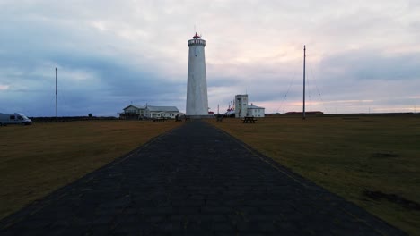 Low-angle-dolly-in-of-a-tall-lighthouse-at-sunrise