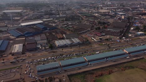 Drone-Video-of-Mbare-High-Density-Suburb-Township-Warehouses-In-Harare,-Zimbabwe