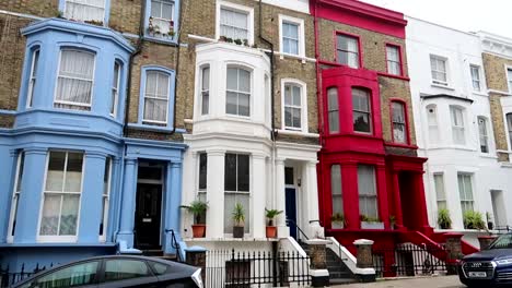 Houses-with-vibrant-colors-and-impressive-facades-in-Portobello-Road-located-in-the-Notting-Hill-neighborhood