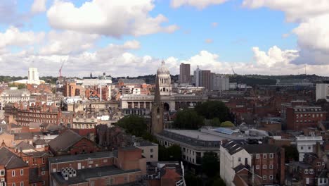 Rapid-dramatic-drone-shot-circling-round-city-centre-of-Nottingham,-England