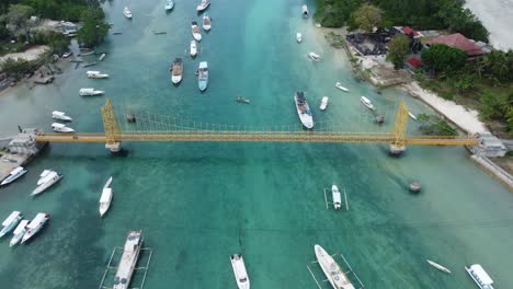 Aerial-4K-Drone-Footage:-Scooters-Crossing-the-Iconic-and-Picturesque-Yellow-Bridge-Connecting-Nusa-Lembongan-and-Nusa-Ceningan-Islands-in-Bali