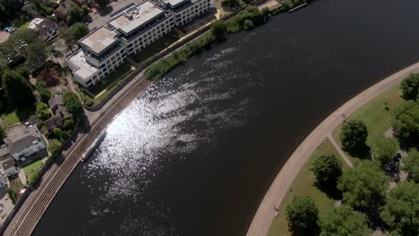 Dramatic-drone-tilt-down-towards-glistening-River-Trent-in-England