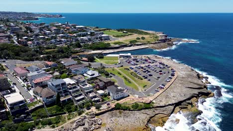 Drone-aerial-headland-coastline-residential-housing-street-cars-apartment-block-units-ocean-foreshore-Gordons-Bay-Clovelly-Carpark-Coogee-Randwick-NSW-Australia-4K