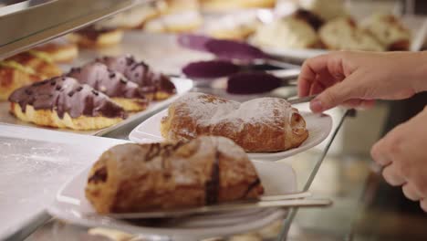 Serving-pastries-and-croissant-in-cafeteria