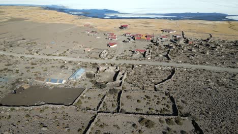 Aerial-of-eco-lodge-in-the-deserted-landscape-of-Salar-de-Uyuni-close-to-the-shore-of-Uyuni-Salt-Lake,-Bolivia