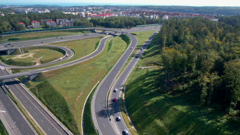 Aerial-backwards-shot-of-large-junction-in-Gdynia-with-overpass-and-underpass-interchange-roads
