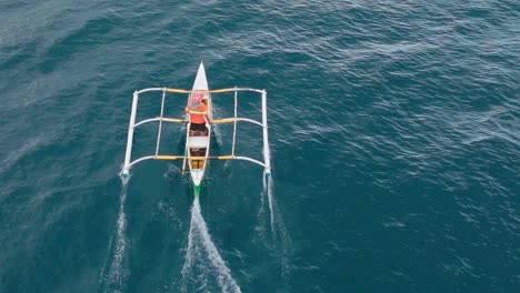 Aerial-of-a-fishermen's-outrigger-being-towed-by-a-large-fish-by-handline