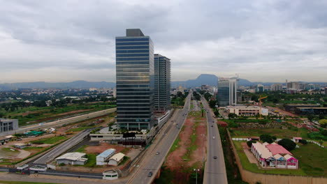 Shot-of-a-road-and-cars-passing-in-the-city-of-Abuja,-Nigeria