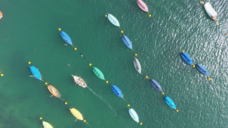 Colourful-sailing-boats-moored-Overhead-birds-eye-drone-aerial-view