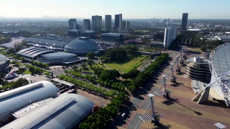 Drone-aerial-view-of-show-ground-Sydney-Olympic-Park-Homebush-Bay-sports-entertainment-concert-venue-area-buildings-park-trees-grounds-towers-NSW-Strathfield-Australia-4K