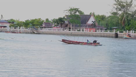 Seen-in-the-middle-of-the-river-and-suddenly-one-arrives-speeding,-Amphawa,-Samut-Songkhram,-Thailand