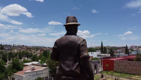 shot-of-the-statue-of-pancho-villa-in-el-parral-doing-a-survey-with-the-drone-to-discover-the-city