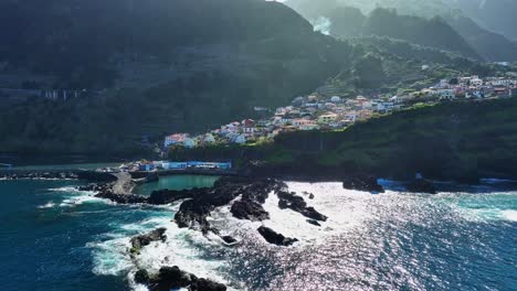 Aerial-view-of-Seixal-pools-and-town-with-crystal-blue-water,-Madeira