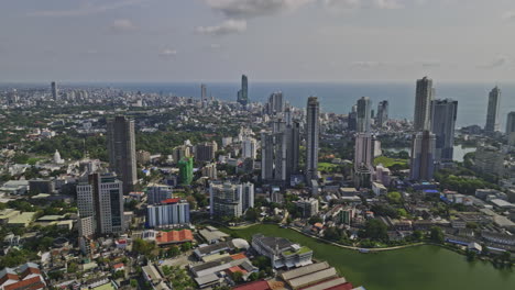 Colombo-Sri-Lanka-Aerial-v4-panoramic-drone-pans-above-area-10-capturing-landmark-Lotus-tower-at-Beira-Lake,-panorama-of-downtown-cityscape-and-city-port---Shot-with-Mavic-3-Cine---April-2023