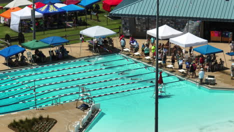 Athlete-Swimmers-Race-On-A-Backstroke-Style-During-Swim-Meet-In-Siloam-Springs,-Arkansas,-USA
