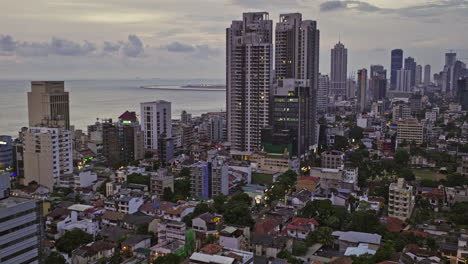 Colombo-Sri-Lanka-Aerial-v32-drone-flyover-Bambalapitiya-and-Kollupitiya-neighborhoods-capturing-dusk-downtown-cityscape-with-residential-and-commercial-buildings---Shot-with-Mavic-3-Cine---April-2023