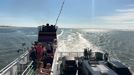 Time-lapse-shot-showing-cruising-german-ferry-ship-leaving-norderney-island-during-sunny-day