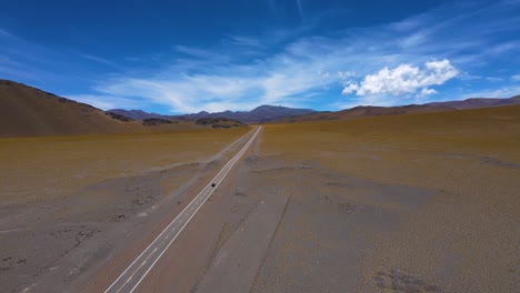 Drone-shot-following-a-car-driving-on-the-ruta-de-los-seismiles-in-Catamarca,-Argentina